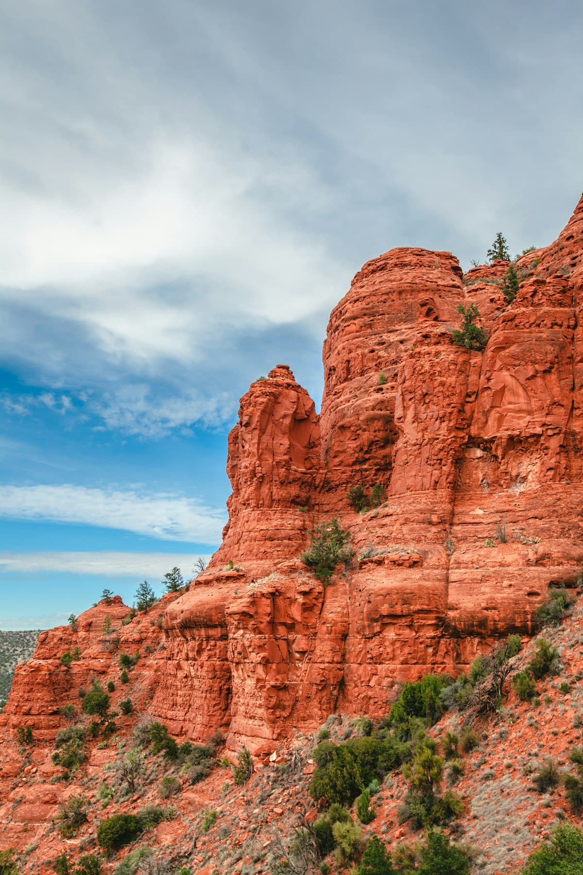 Sunlit red rock formation rising above Sedona's canyon