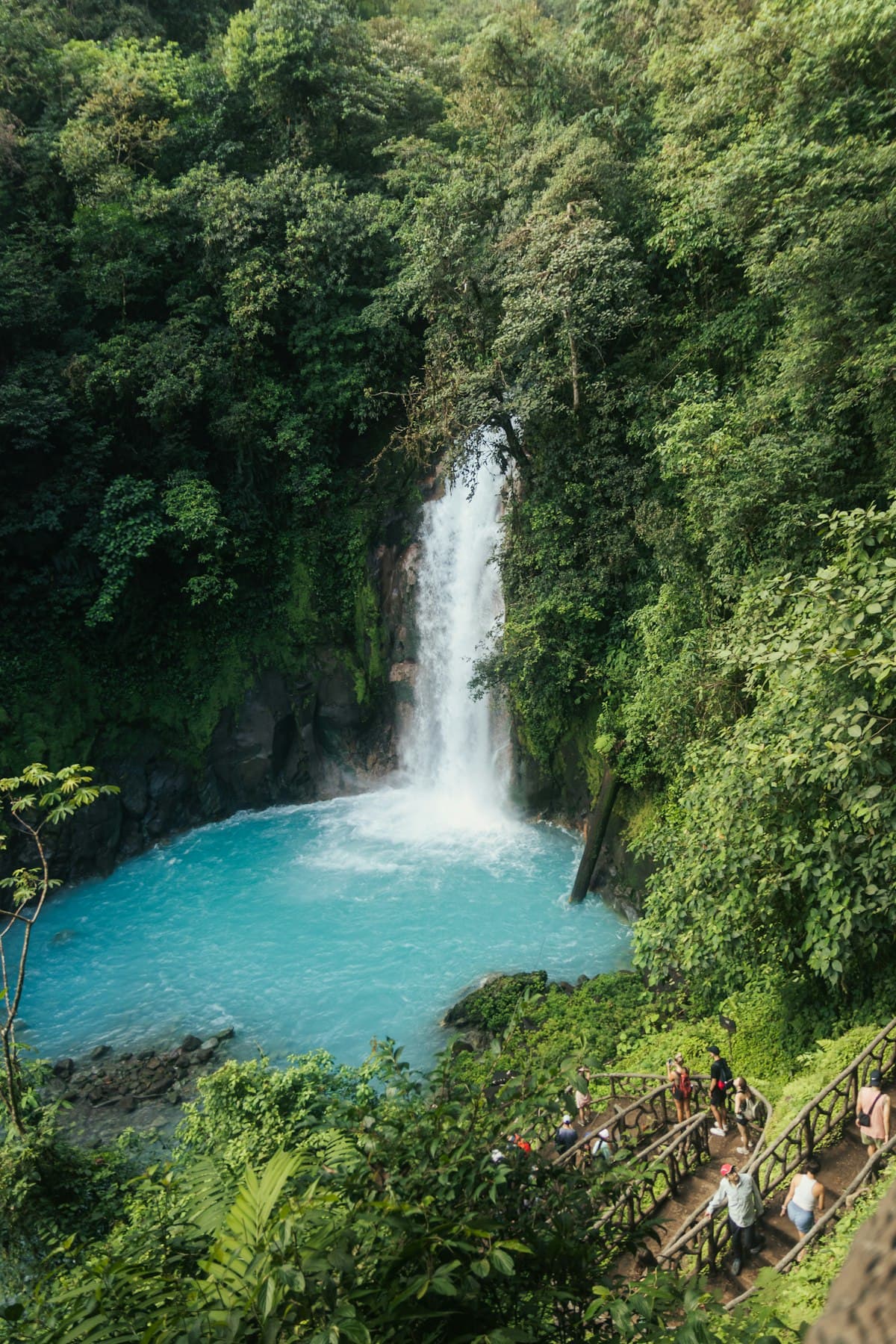 Waterfall pouring into a turquoise pool in the Costa Rican rainforest
