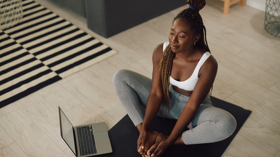 Woods guiding a gentle virtual yoga flow