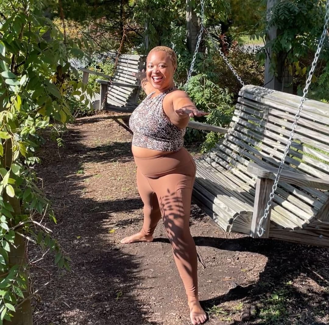 Woods practicing yoga outdoors